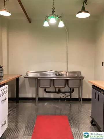 Kitchen three-bay sink.