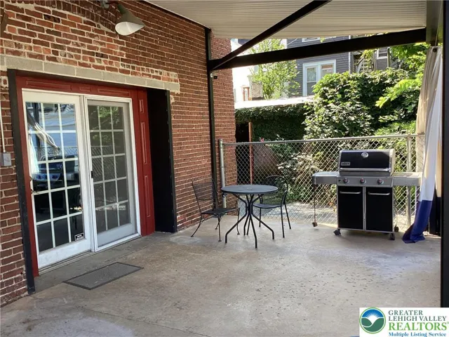 Covered rear patio off parking lot.