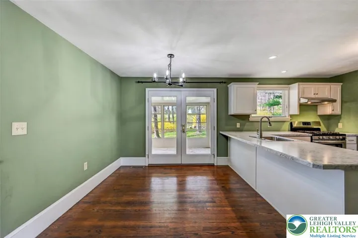 Dining Area w/ French Doors To Sunroom