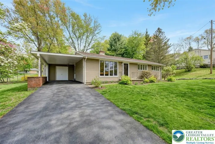 Long Paved Driveway To Carport