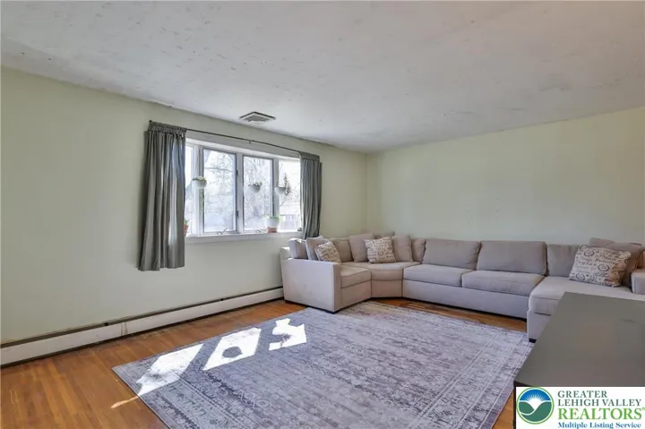 LR with hardwood flooring, new windows