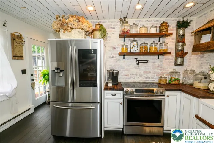 Brick accent walls, real reclaimed wood shelves & convenient pot filler!