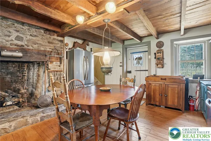 Original wood plank floors, natural wood ceilings, stone fireplace