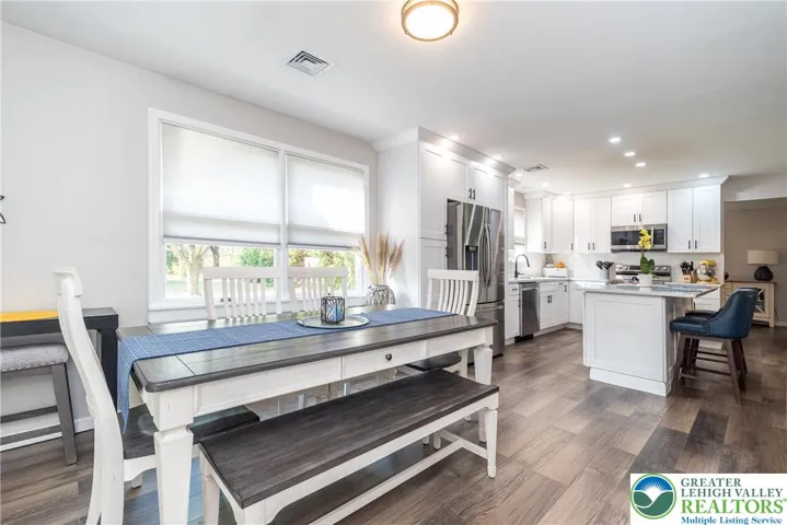 Family Room open to Kitchen, staged as Dining Area