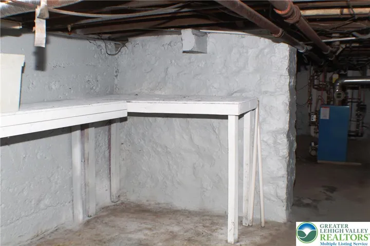 Rear area of basement, has the egress stairs to Bilco doors.
