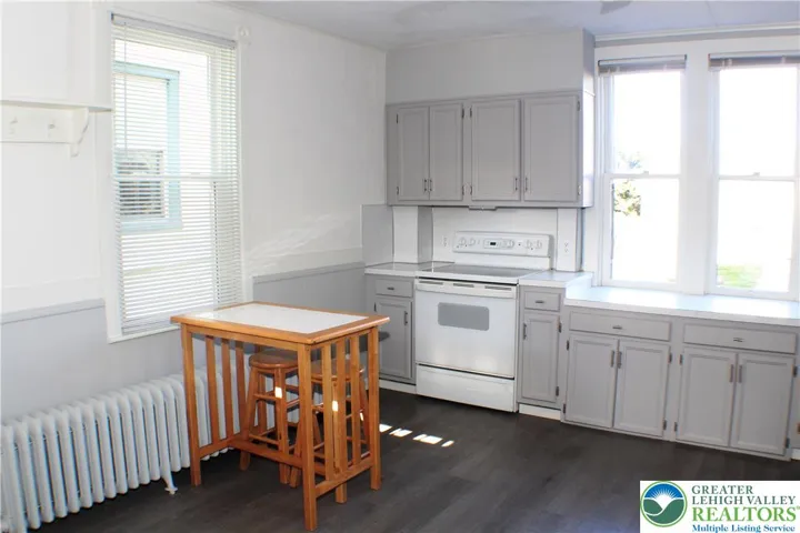 Kitchen, Eat=in capable, and mega windows. Electric flat top stove