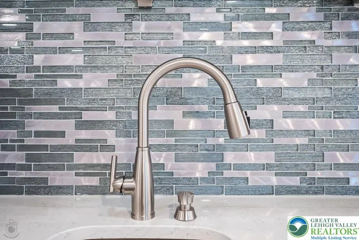 Lower Level Kitchenette w/ Full Sink & Stainless Tile Back spalsh.