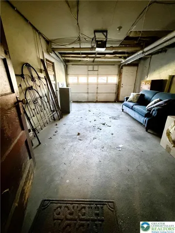 oversized garage in back leads to basement. Small utitily room with electric to the left.