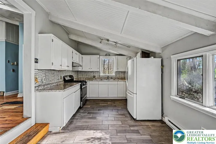 The Kitchen steps down from the Living Room and has newer tile floors throughout.
