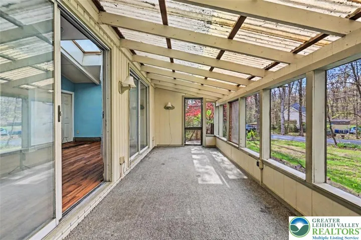 The screened porch has 2 sconce lights and double sliders to the Living Room.
