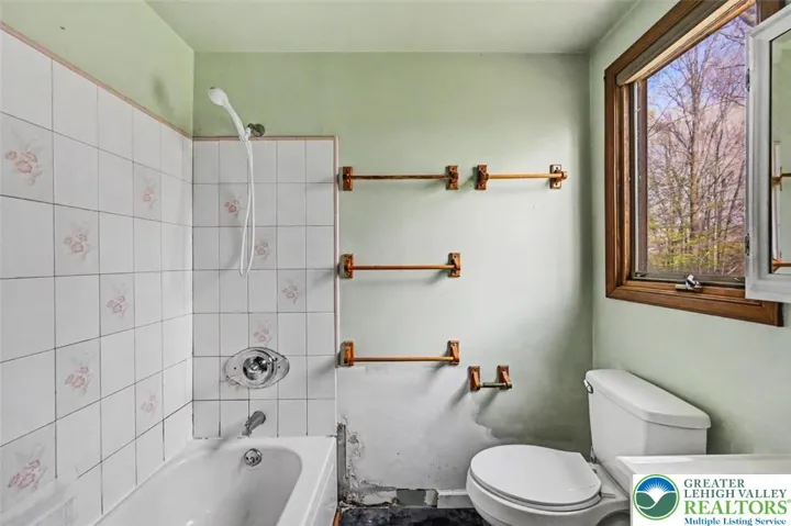 Bedroom 2 includes a private Full Bath with tiled tub surround.
