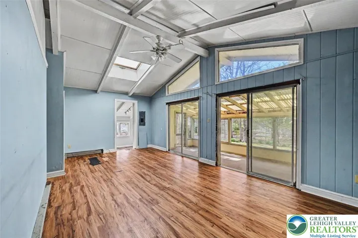 The Living Room is spacious with beamed ceiling and features a double closet and leads into the Kitchen & Dining Area.
