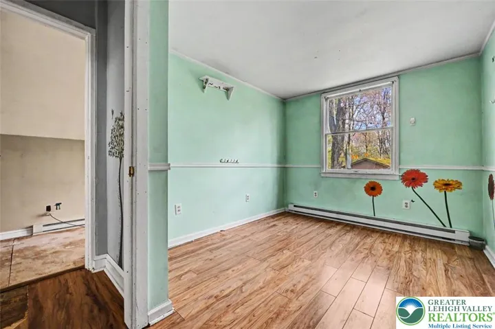 Bedroom 3 has laminate floors, a yard-facing window, a single closet with built-in shelves and can accommodate a twin sized bed.

