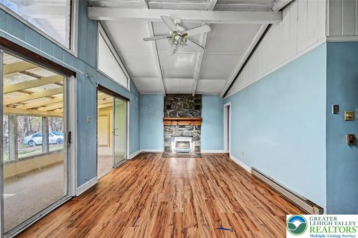The Living Room has laminate flooring and a vaulted ceiling with skylight and a lighted ceiling fan.
