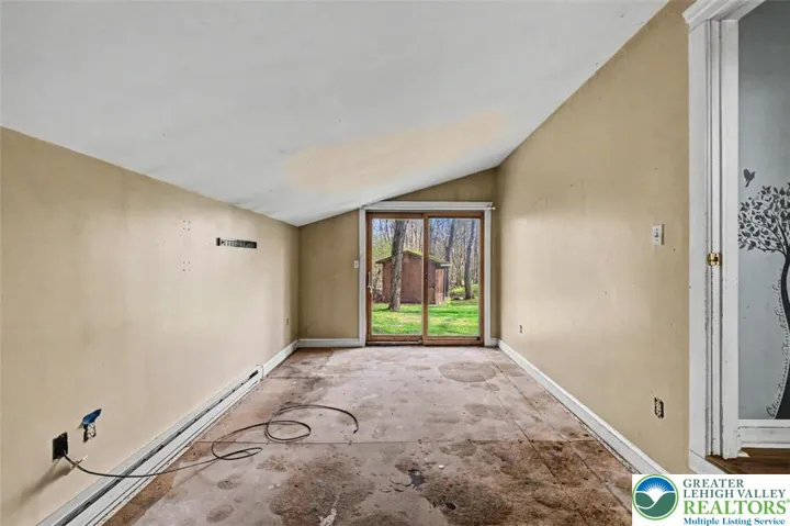 The Primary Bedroom is spacious with vaulted ceilings, subfloors only, and a slider to the yard).
