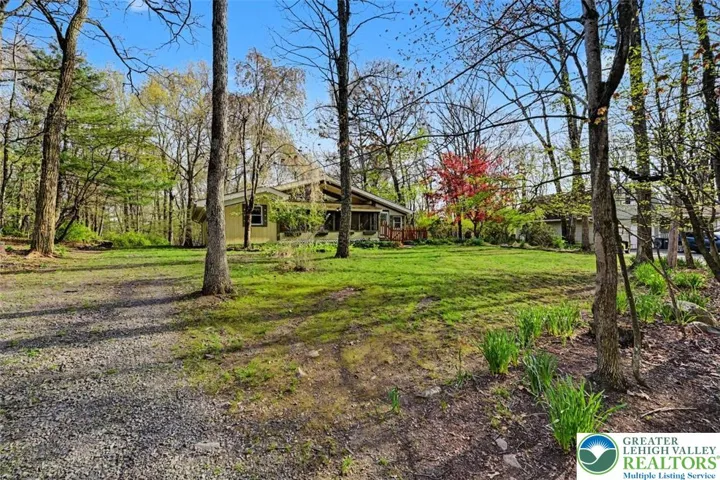 The home sits back from the street for privacy and features a long driveway with plenty of parking.
