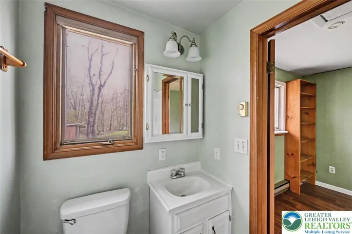 Private Bath 2 has a single vanity with storage and a lighted medicine chest.
