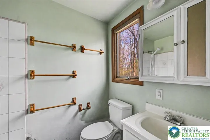 Private Bath 2 has vinyl flooring and a yard-facing window.
