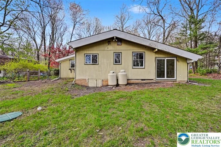 House back with slider leading to the Primary Suite and entrance to the crawl space.
