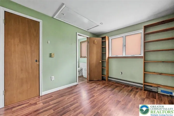Bedrpom 2 has a single closet with built-in shelving and features a pull-down staircase to the attic.
