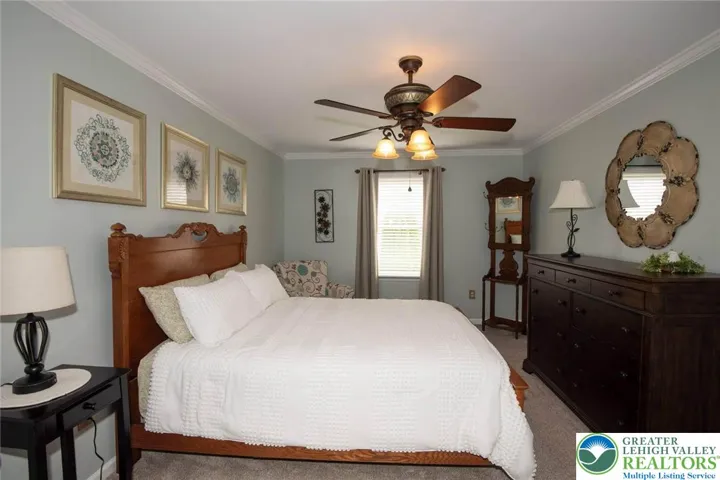 bedroom 2, carpeted, ceiling fan, crown molding and very spacious