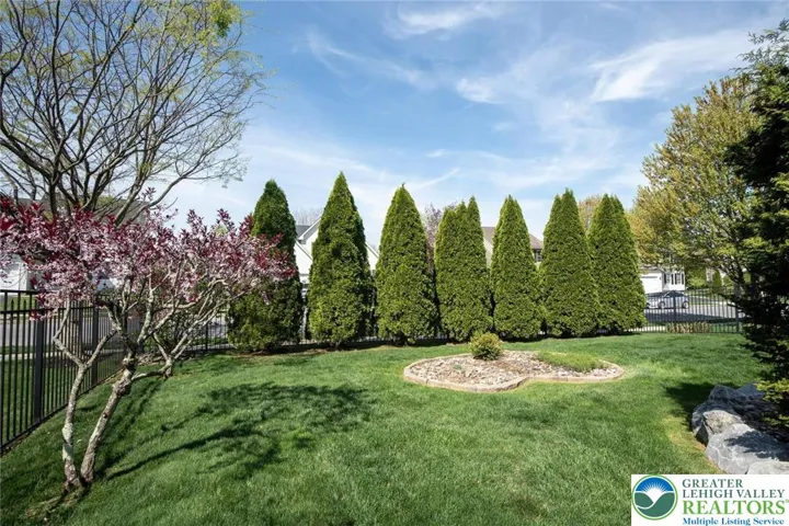 private tree lined yard with foliage starting to bloom