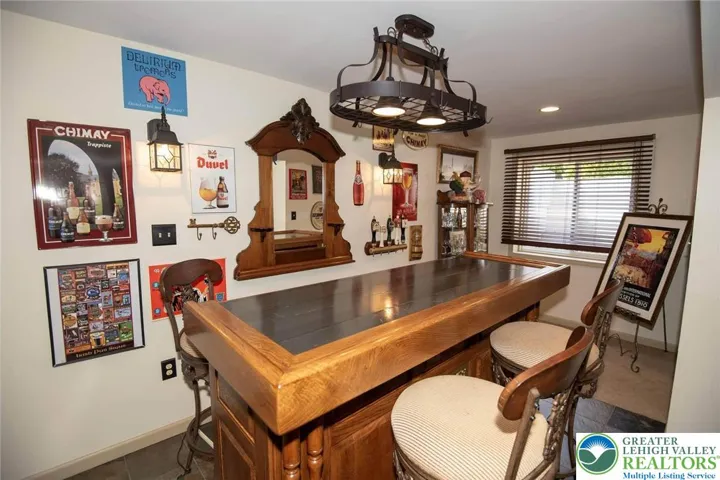 Bar area in the lower level (bar and stools remain); escape window int he rear