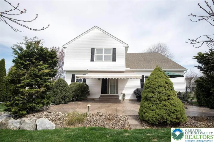 view of the back of home with professional landscaping