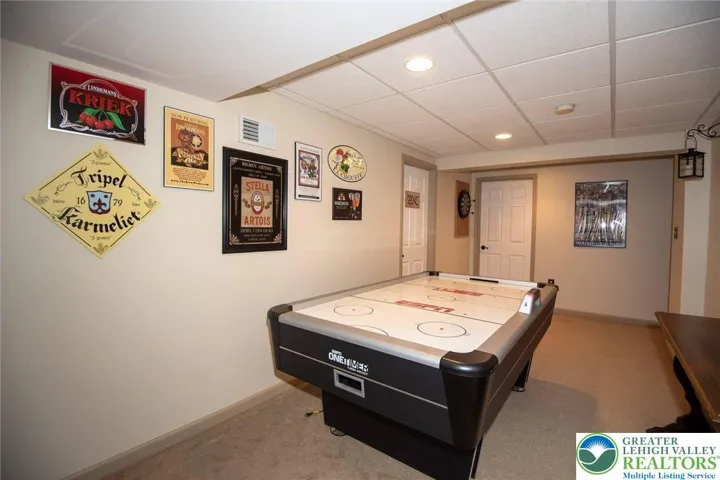 game area in the lower level; air hockey table remains with home
