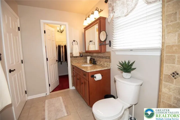Tiled Primary Bath opens to a walk in closet