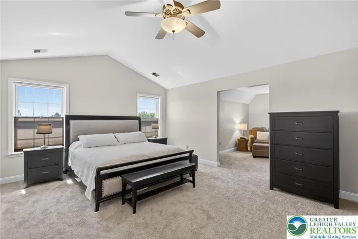 Spacious primary bedroom with cathedral ceilings