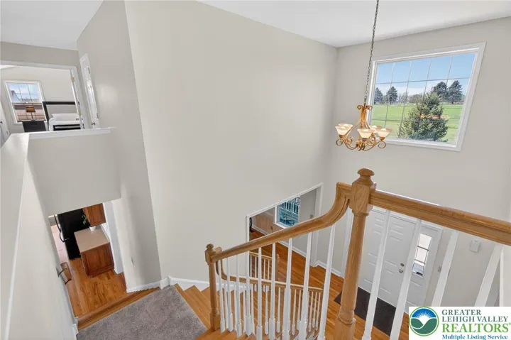 Dual staircase layout from foyer and kitchen