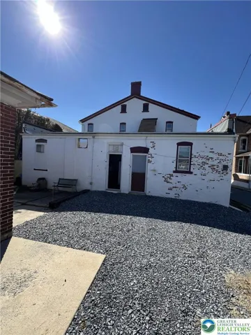 back entrance to kitchen, apartment entrance, and parking spaces
