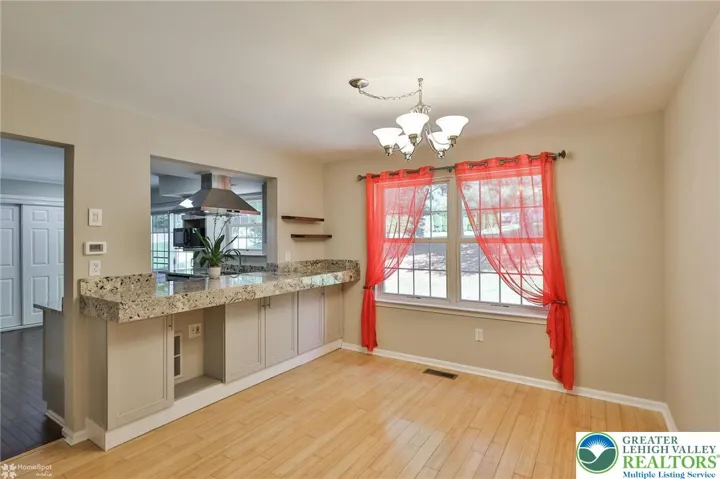 Dining room with extra storage, breakfast bar, and bamboo flooring