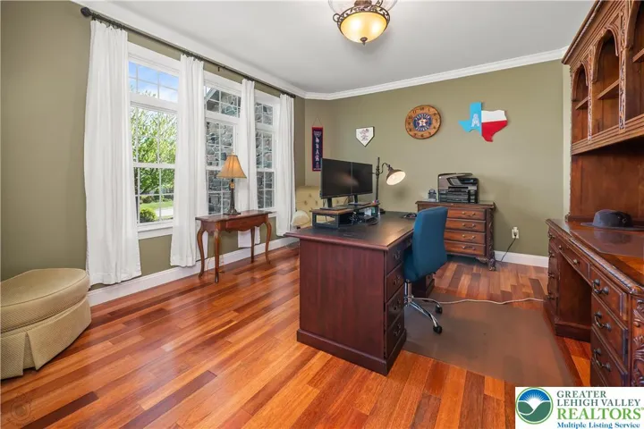 Spacious home office with french doors on the left.