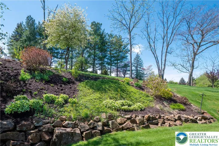 This beautifully planted bank at the back of the house and the deck offers a feeling of privacy, and enjoyment of the plantings.