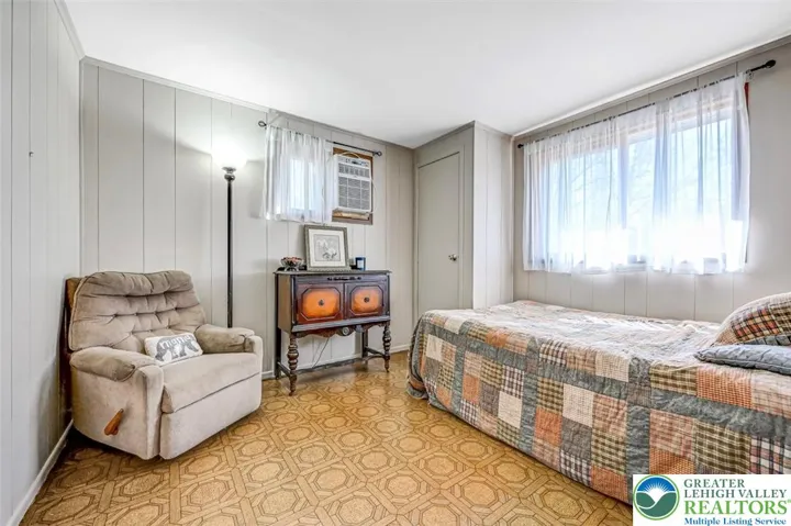 Bedroom 2 has vinyl flooring and two double windows (Window A/C unit included).
