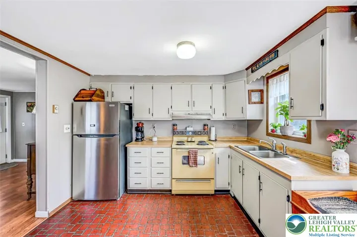 The Kitchen features freshly painted wood cabinetry and ample counter and cabinet space.
