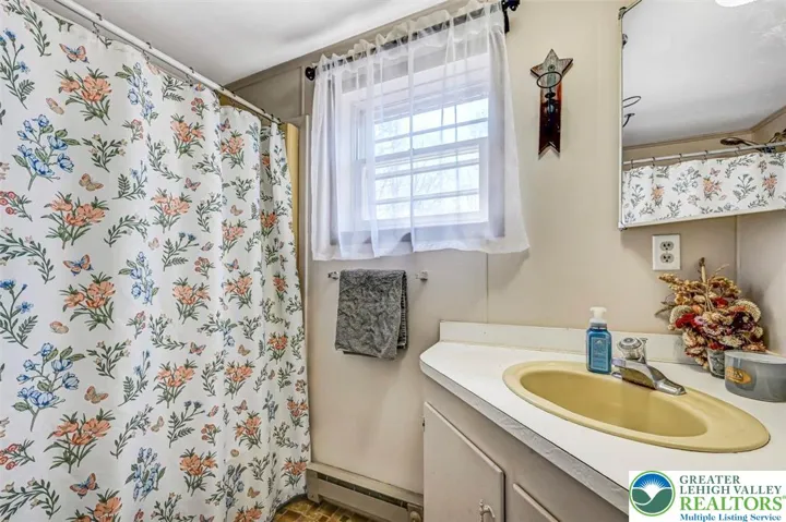 The Bathroom has vinyl flooring, a full tub and window overlooking the back yard.
