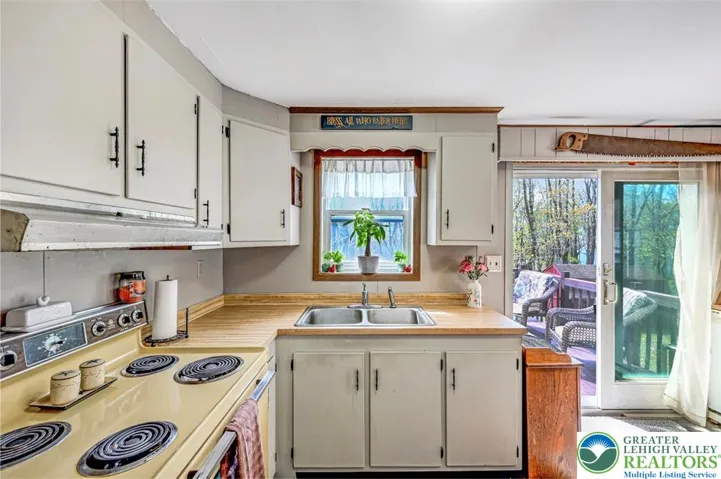 The Kitchen is light and bright with a window and large slider overlooking the large back deck.
