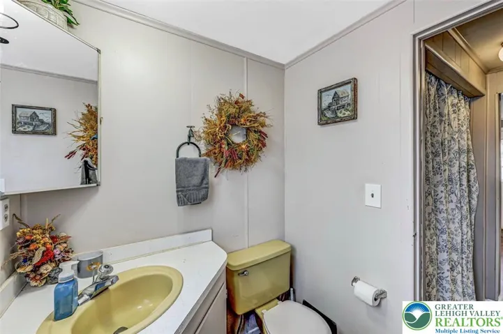 The Full Bath leading out to the Hallway and Laundry Area (Full sized washer/dryer included).
