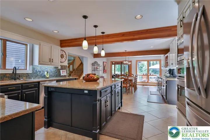 large center island with gleaming granite counter tops