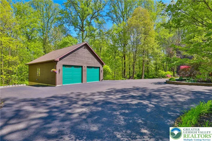 Detached 2 bay heated garage with workshop area.  Shop includes an air filtration system and vacuum.  All other shop equipment is for sale but NOT included in the purchase price