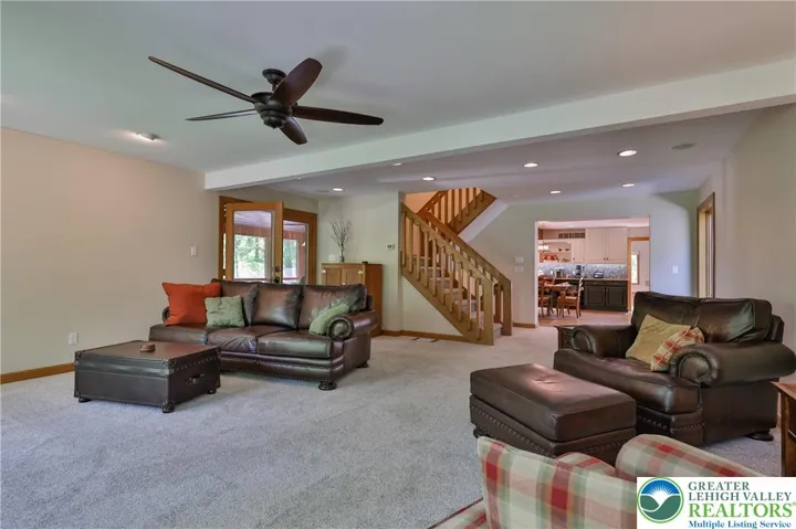 Family room off the kitchen with access to screened porch
