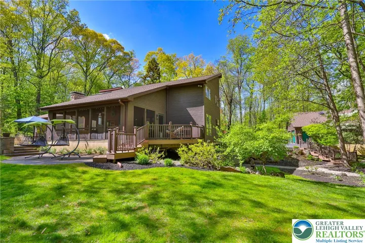 Rear view, multi level patios, deck and screened porch