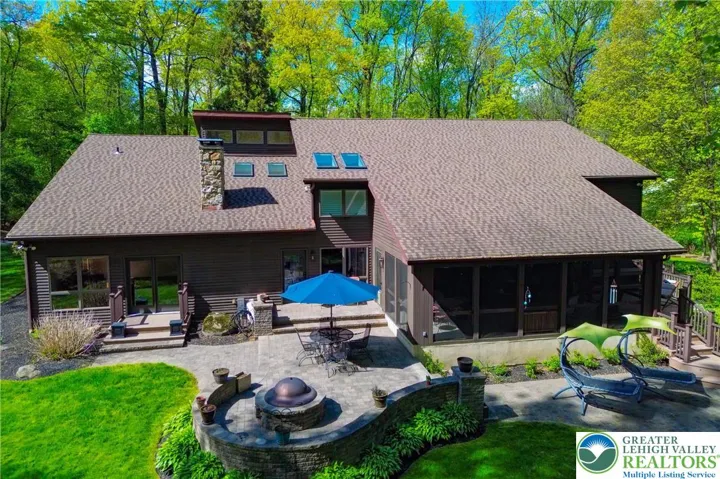 Rear view, multi level patios, deck and screened porch