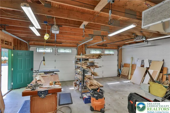 Detached 2 bay heated garage with workshop area.  Shop includes an air filtration system and vacuum.  All other shop equipment is for sale but NOT included in the purchase price