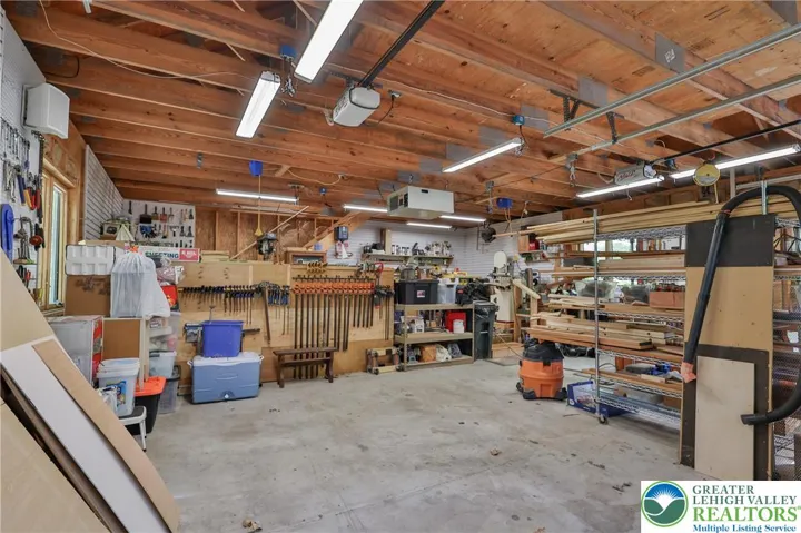 Detached 2 bay heated garage with workshop area.  Shop includes an air filtration system and vacuum.  All other shop equipment is for sale but NOT included in the purchase price