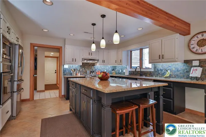Kitchen sits off the mud room and laundry area adjacent to the built in garage