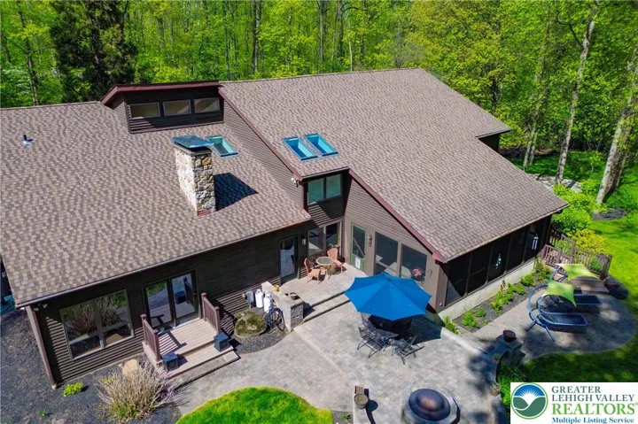 Rear view, multi level patios, deck and screened porch